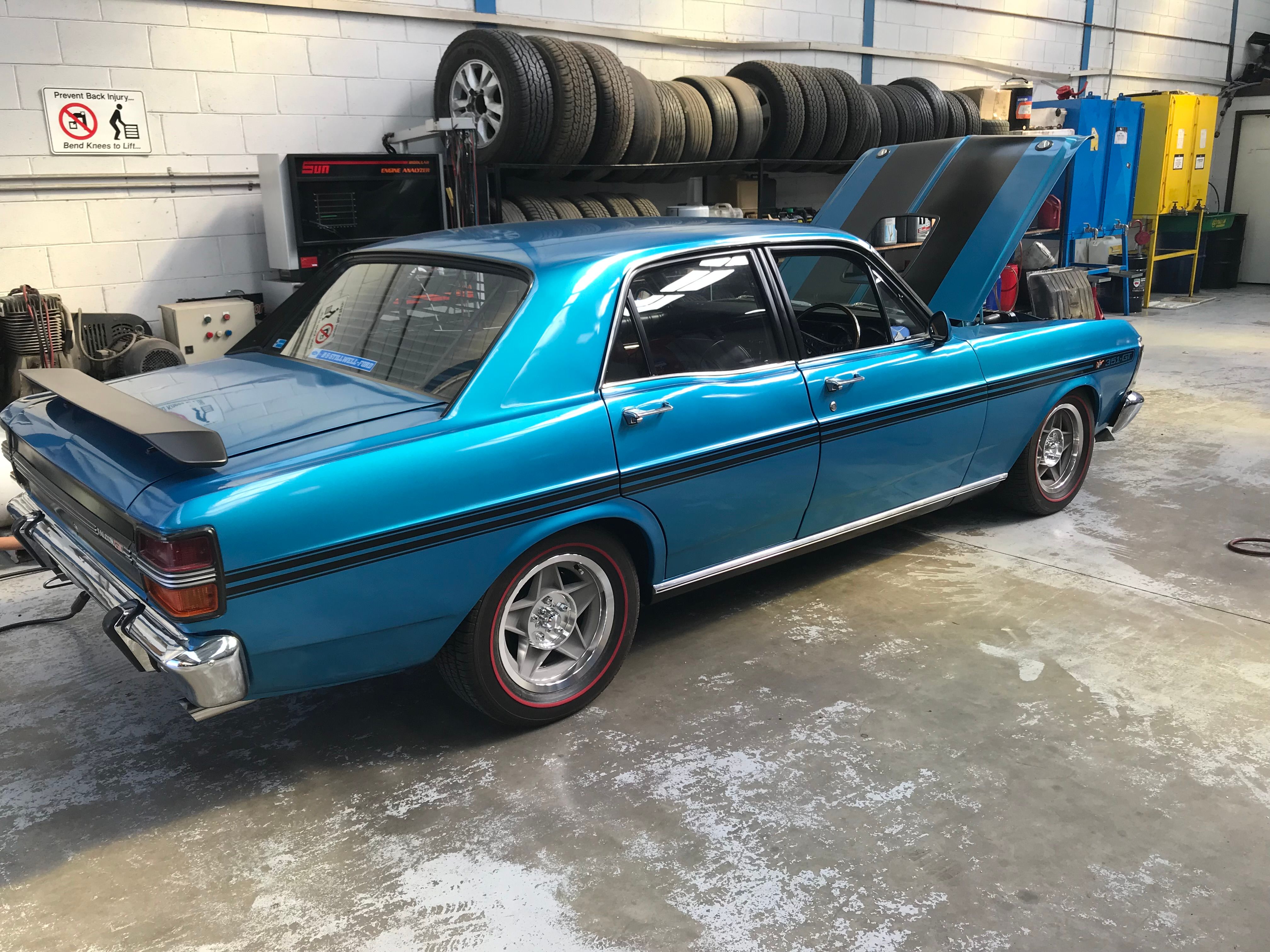 Blue classic sedan inside the Superior Mechanical workshop