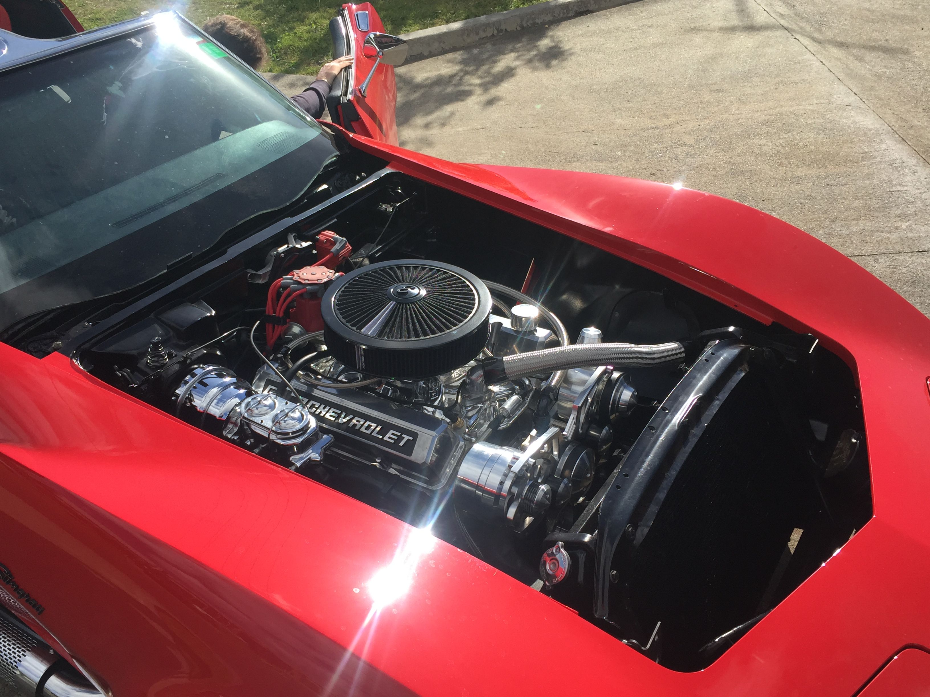 Polished Chevrolet engine in a red classic car